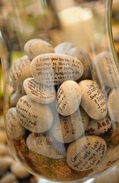 a glass jar filled with lots of rocks and writing on the inside of it's lid