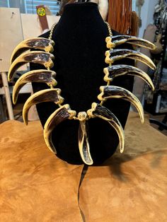 a necklace made out of cow's teeth on a mannequin headdress