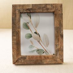 a wooden frame with some leaves in it