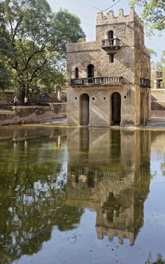 an old building is reflected in the water