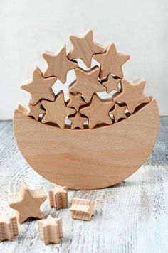 a wooden bowl filled with stars on top of a table