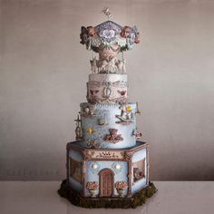 there is a multi layer cake with many decorations on it's tiered tower