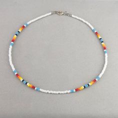 Western style beaded choker necklace features glass seed beads in white, turquoise, hues of red and orange along with tiny black seed beads. A sturdy lead and nickel free lobster clasp ensures a secure and comfortable fit. The vivid and bright colors of this western style necklace make it the perfect gift. Measurements(approx. see 3rd photo) Necklace Length:15.5"(including clasp) Beads:3 mm Seed Bead Western Necklace, Western Necklaces, Beaded Necklace Patterns, Beaded Necklace Designs, Bead Choker, Clay Bracelet, Diy Bracelets Patterns, Necklace Patterns, Photo Necklace