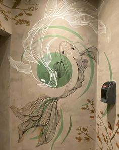 an artistic mural on the side of a wall next to a toilet paper dispenser