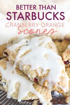 cranberry orange scones with white icing are stacked on top of each other