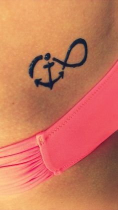 a woman's stomach with an anchor tattoo on it