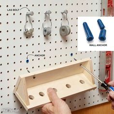 a man is working on a pegboard with several different tools attached to the peg board