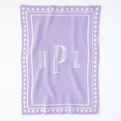 a purple and white towel with the letter p on it