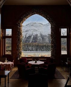 a living room filled with furniture next to a large window covered in frosted snow