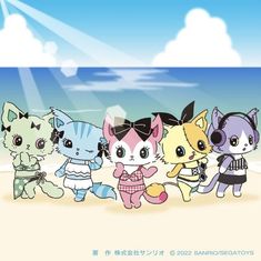 a group of cute little kittens standing on top of a beach