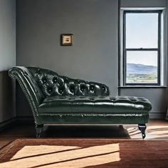 a green leather chaise lounger in an empty room