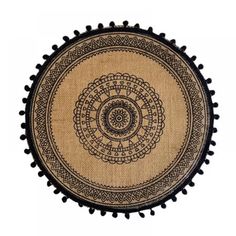 a round rug with black pom - poms on the bottom and an intricate design