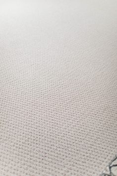 a close up view of a white rug with black writing on the top and bottom