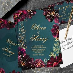 the wedding stationery is set on top of some paper and gold foiled envelopes