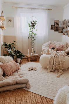 a living room filled with lots of white furniture and pillows on top of a rug