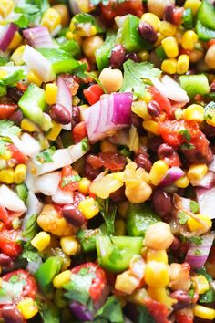 a colorful salad with beans, onions and cilantro