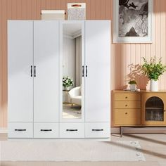 a white wardrobe in a room with pink walls