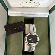 1400l - Silver, Stainless Steel Women's Quartz Watch With Black Face And "Gucci" Logo At 12 Marker/Back Clasp And Signature "Horsebit" Clasp Case Color: Silver Face Color: Black Dial Color: Silver Case Material: Stainless Steel Band Material: Stainless Steel **Brand New With Tags And Box** Silver Designer Watches, Formal Gucci Jewelry With Diamond Hour Markers, Classic Gucci Watch For Formal Occasions, Designer Silver Watches For Evening, Elegant Formal Jewelry With Silver-tone Hardware, Designer Silver Business Watches, Designer Gucci Watch For Evening, Designer Silver Watch For Formal Occasions, Designer Silver Formal Watch