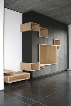 an empty room with wooden shelves on the wall and tile flooring in front of it