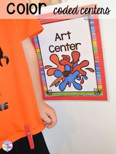 a young boy wearing an orange t - shirt and black pants with the words art center on it