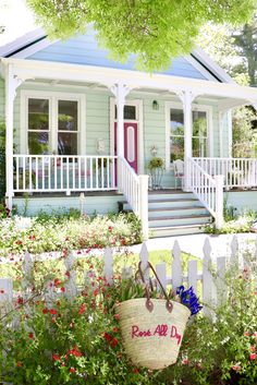 a house with flowers and a basket in the front yard