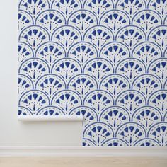 a blue and white wallpaper with an intricate design on the wall next to it