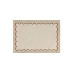 a beige place mat with scalloped edges and a brown border on the side