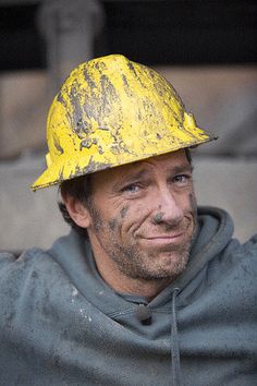 a man wearing a yellow construction hat