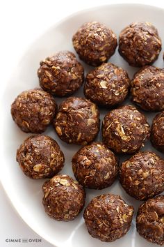 a white plate topped with chocolate balls covered in nuts