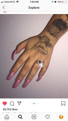 a woman's hand with tattoos on it and a ring in her left hand