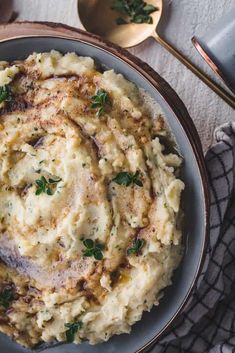 mashed potatoes in a bowl with parsley on top