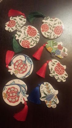 some decorative items on a table with tassels in the shape of flowers and birds