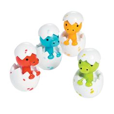 four small toy animals sitting on top of an eggshells in different colors and shapes