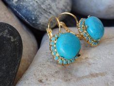 Gold Turquoise Drop Earrings, Turquoise Jewelry, Blue Gemstone Earrings, Reiki Earrings, Rounded Turquoise Earrings, December BirthstoneThese earring have a big wow factor. No one can ignore you when your wear These. They look like they belong to a royal princess of an ancient era. Great for a party or anytime you want to look glamorous and chic.Metal: 24K Gold platedGemstone: Turquoise, SwarovskiLength: 1.4 cm (0.55 Inches)Stone Size: 1 cm (0.4 Inches)The earrings will be packed in a gift box.P Luxury Turquoise Oval Earrings, Turquoise Gemstone Drop Earrings, Turquoise Drop Earrings With Gemstone Accents, Turquoise Earring, Blue Gemstone Earrings, Lapis Jewelry, Turquoise Drop Earrings, Earrings Turquoise, Royal Princess