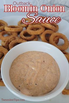 a white bowl filled with sauce next to onion rings on a plate and the words outback bloomin onion sauce