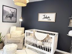 a baby's room with a chair, crib and pictures on the wall