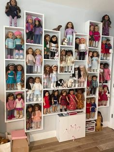 a room filled with lots of dolls and bookshelves on top of each other