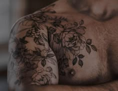 a man with flowers on his chest and arm