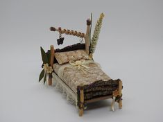 a dollhouse bed with flowers and decorations on it