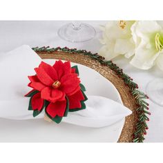 a white plate topped with a red poinsettia