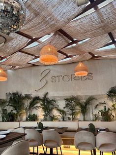 the interior of a restaurant with disco balls hanging from the ceiling