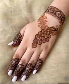 a woman's hand is decorated with hennap and flowers on it,