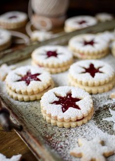 cookies with icing and stars are on a baking sheet