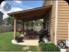 a backyard with a grill, table and chairs