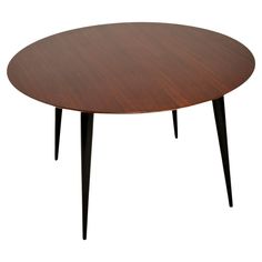 an oval wooden table with black legs and a brown wood top, on a white background