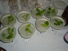 there are many glasses that have green leaves in them