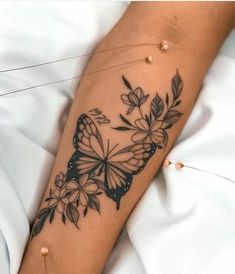 a woman's arm with a butterfly tattoo on it