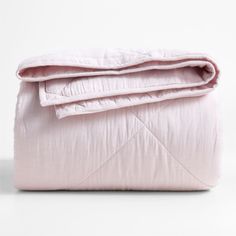 an unmade bed with pink sheets and pillows on it's side, in front of a white background