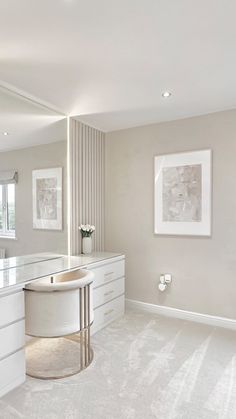 a white bathroom with a sink and large mirror