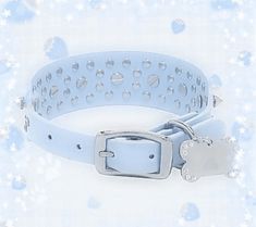 a white dog collar on a blue background with snowflakes and stars around it